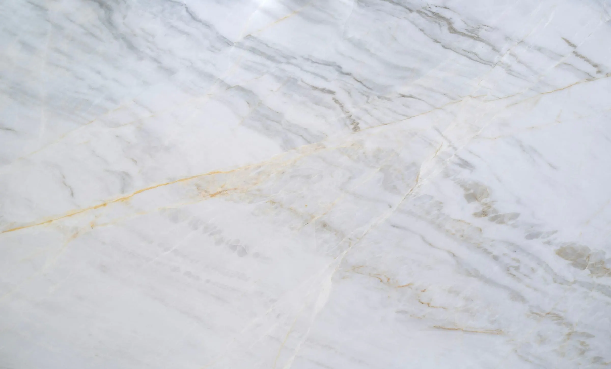 A single gold vein across cream marble